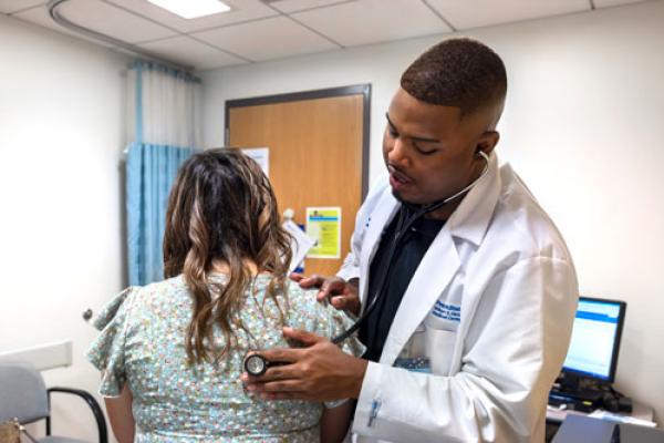 Physician assistant at the Carlino Family IBD Center checks the vitals of a patient during appointment.