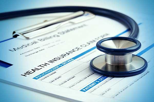 Stethoscope on health insurance claim form.