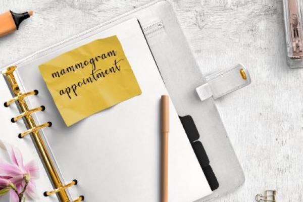 Reminder note in a scheduling book to schedule a mammogram.