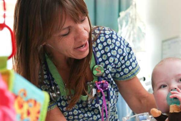 A nurse helps a Penn State Children’s Hospital patient.