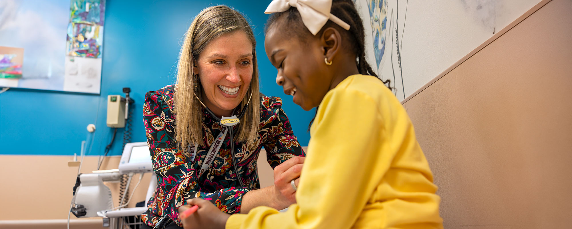 Medical provider examining a young child in a medical clinic.