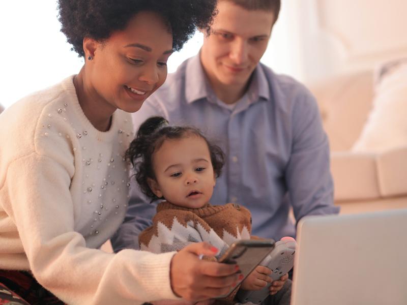 A biracial family makes an appointment via phone