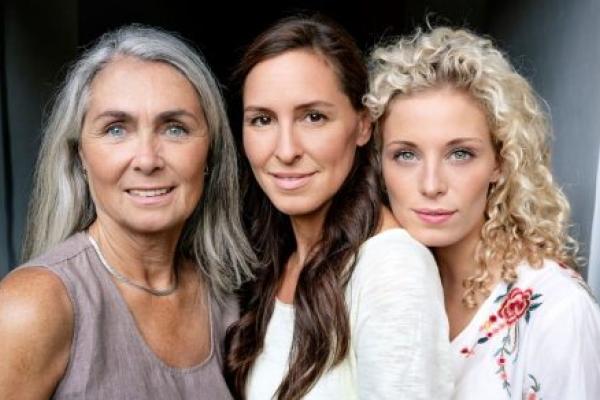 Portrait of three smiling women of different ages