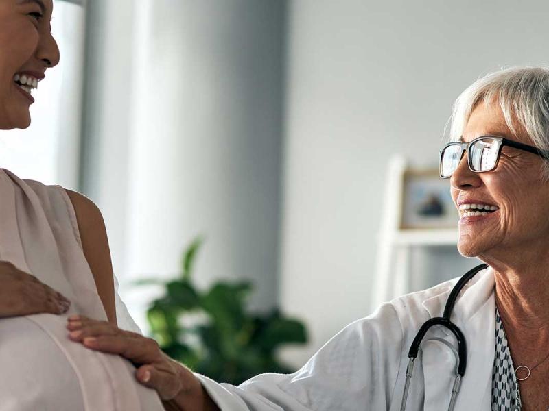 Pregnant woman having a consultation with a female doctor.