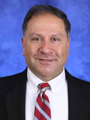 Maher Hanna, in a professional head and shoulders photograph.