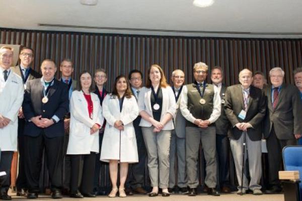 A group of faculty members who have been appointed to endowed positions at Penn State College of Medicine since 2021 gather on a stage for a group photo prior to the Spring 2023 Dean’s Lecture on Tuesday, May 9.