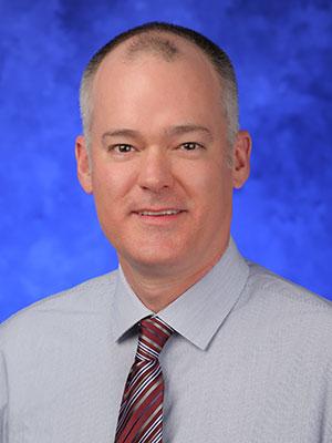 Douglas Leslie, PhD professional head and shoulders photograph.