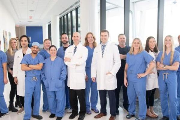 A group photo of the orthopedic team at Penn State Health Lancaster Medical Center. The team stands together in a medical facility, smiling.