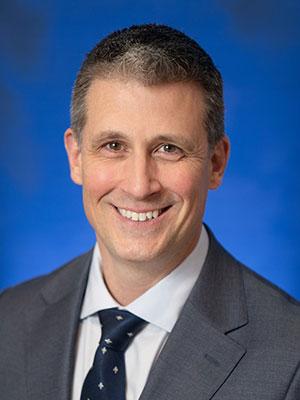 Joseph MacDonald, in a professional head and shoulders photograph.