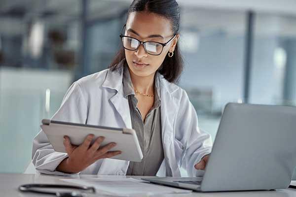 Female doctor using a digital tablet at work.