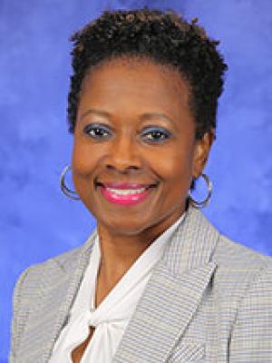 Mona Miliner, in a professional head and shoulders photograph.