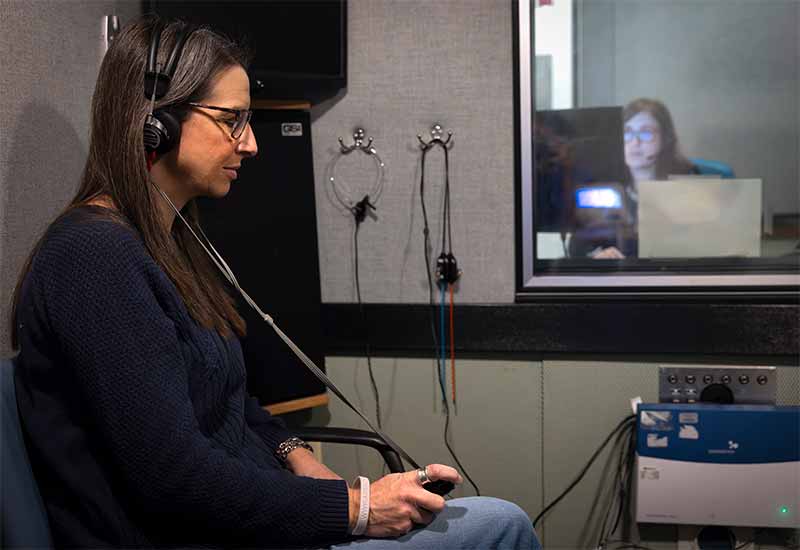 A patient participates in an aided hearing evaluation.