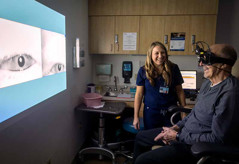 An audiologist prepares a patient for videonystagmography (VNG) testing.