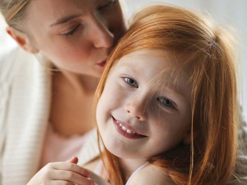 A mother Kissing Her Child