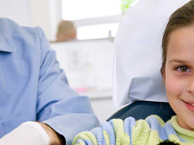 Young girl being examined by a clinician