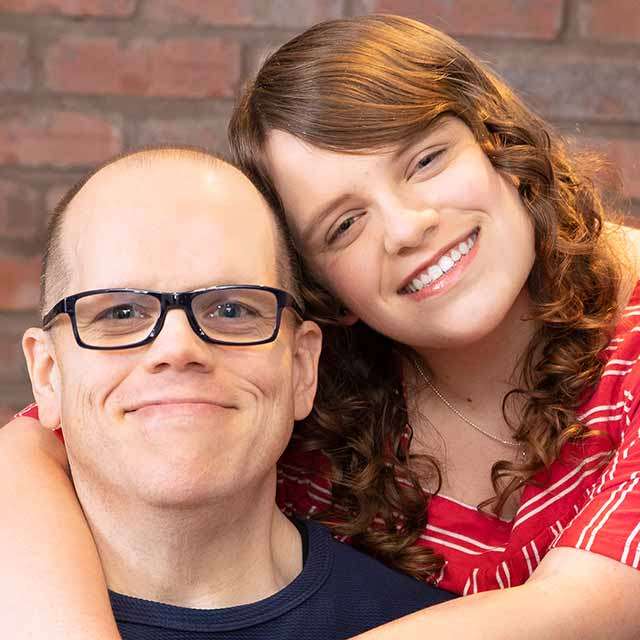 A closely cropped photo of Dennis Guzy, with his daughter standing next to him.