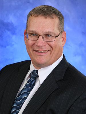 Stephen Speece, in a professional head and shoulders photograph.