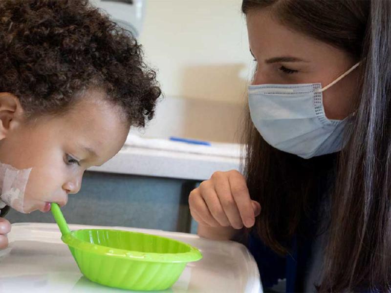 A pediatric patient participates in feeding therapy.