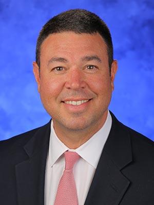 Tom Stoessel, in a professional head and shoulders photograph.