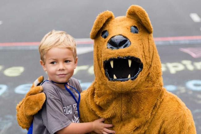 Young boy posing with the Penn State Nittany Lion