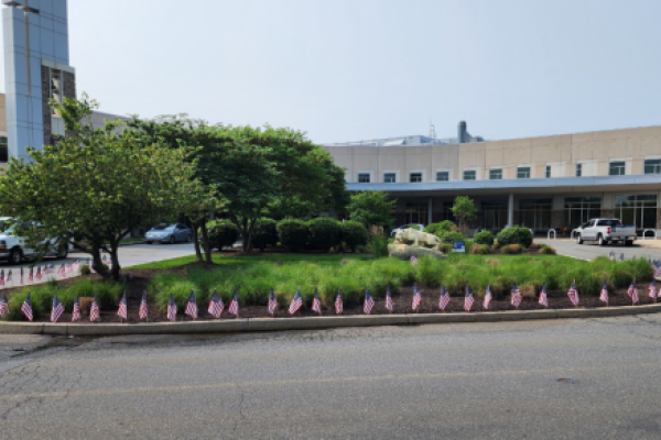 Small American flags stuck in the ground around a garden in front of a St. Joseph Medical 168全国开奖官网 Center
